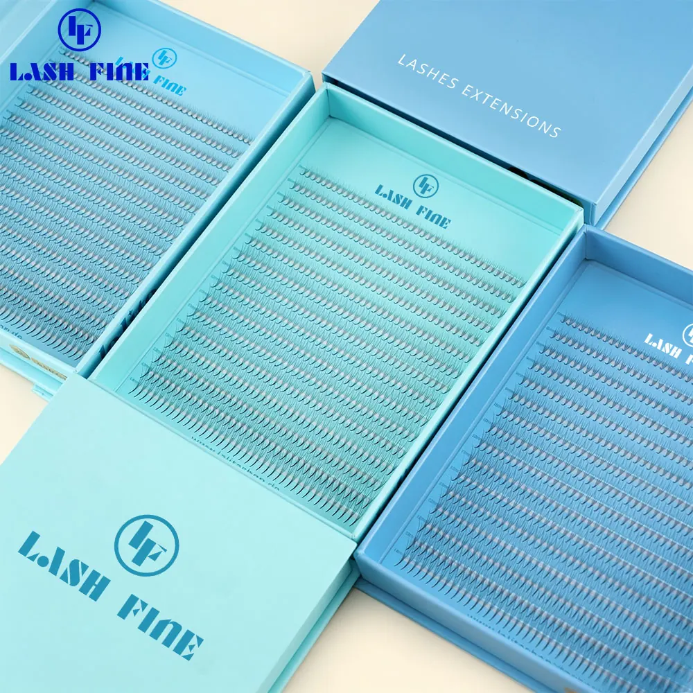 Pre-made lash clusters arranged in rows inside blue flip-lid Lash Fine boxes