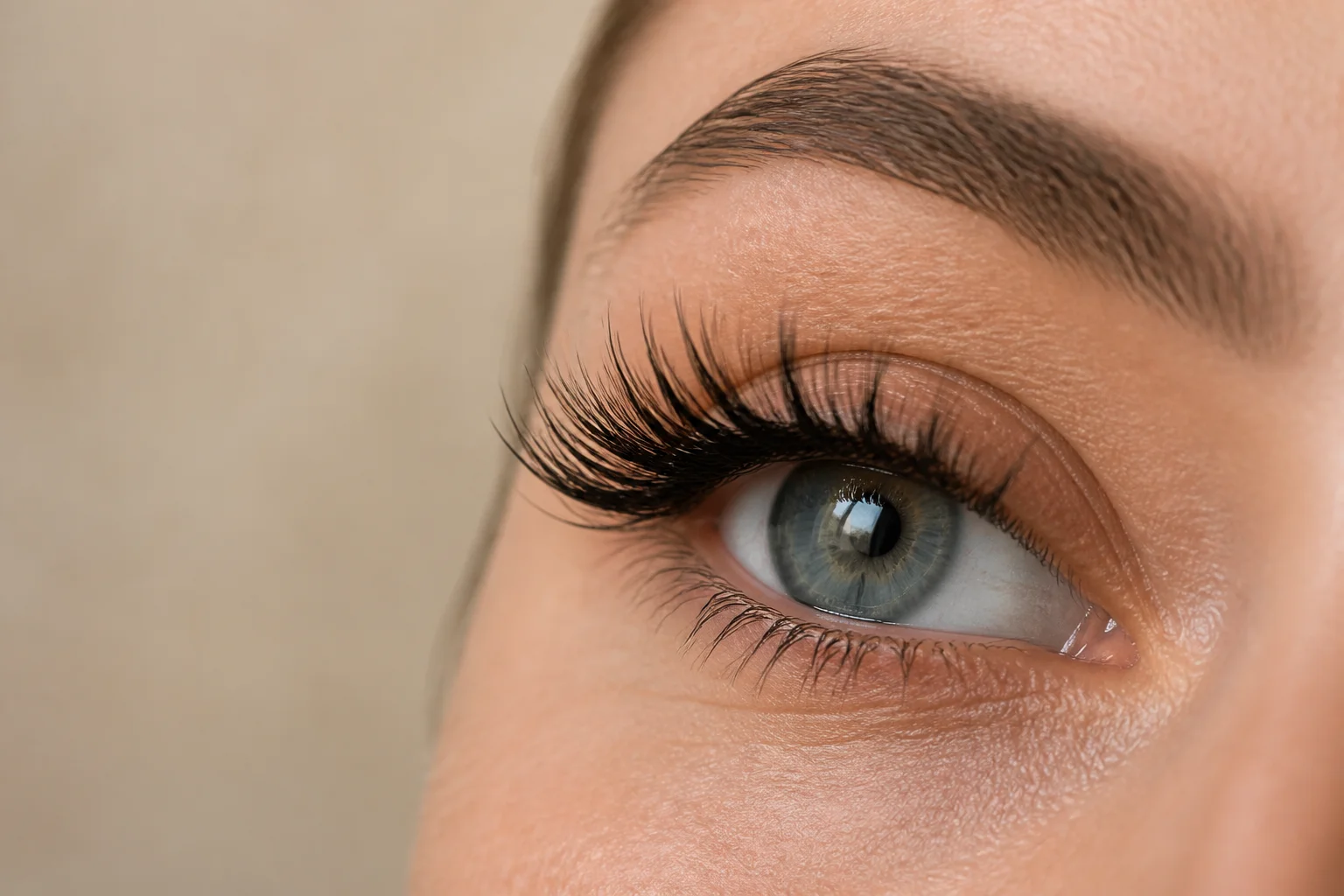 Open eye wearing a finished hybrid lash set with wispy spikes over a soft dense base