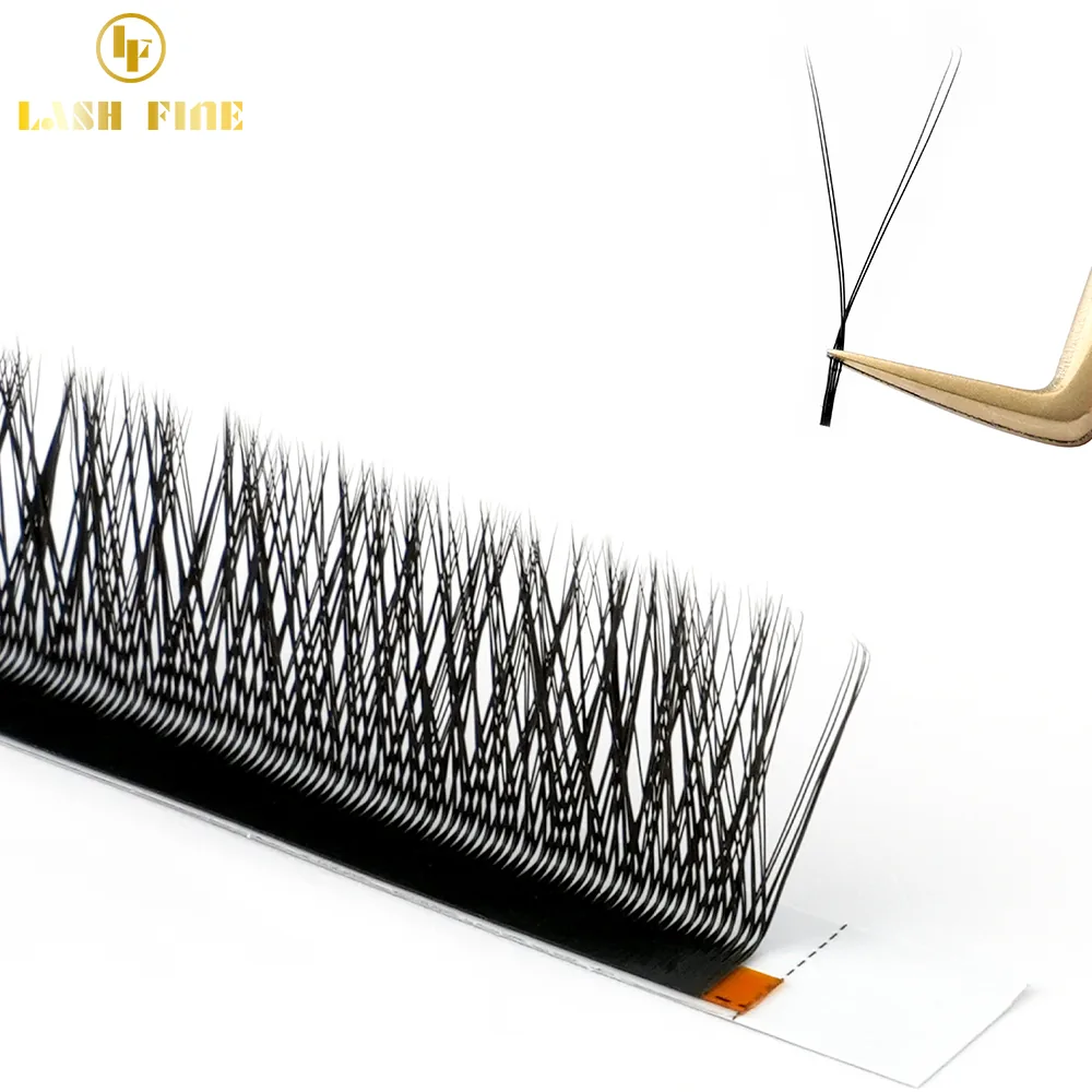 YY premade lash fans standing in rows on a tray while gold tweezers lift one Y-shaped cluster