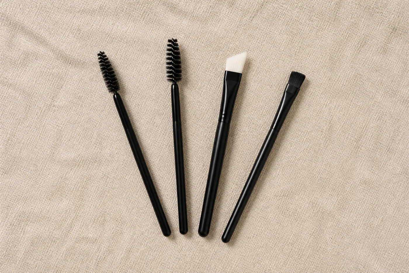 Unbranded lash brush set: two spoolie wands, an angled cleaning brush and a flat applicator brush
