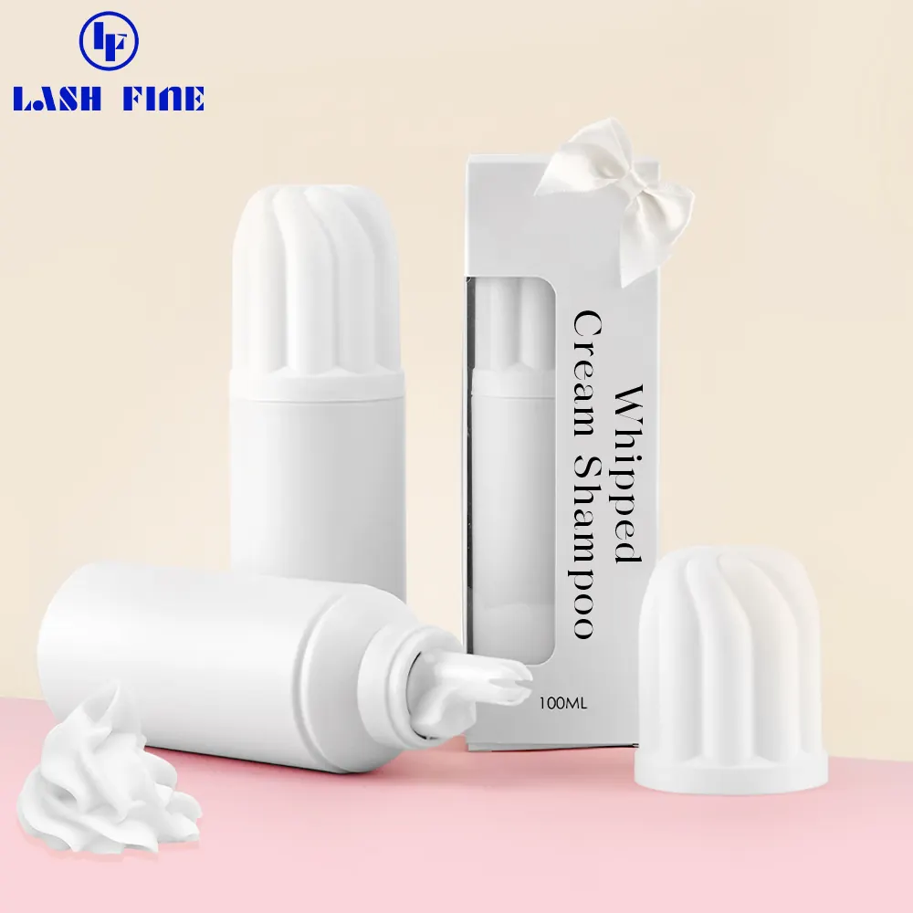 Whipped cream lash shampoo bottle in a pink window box shown with foam