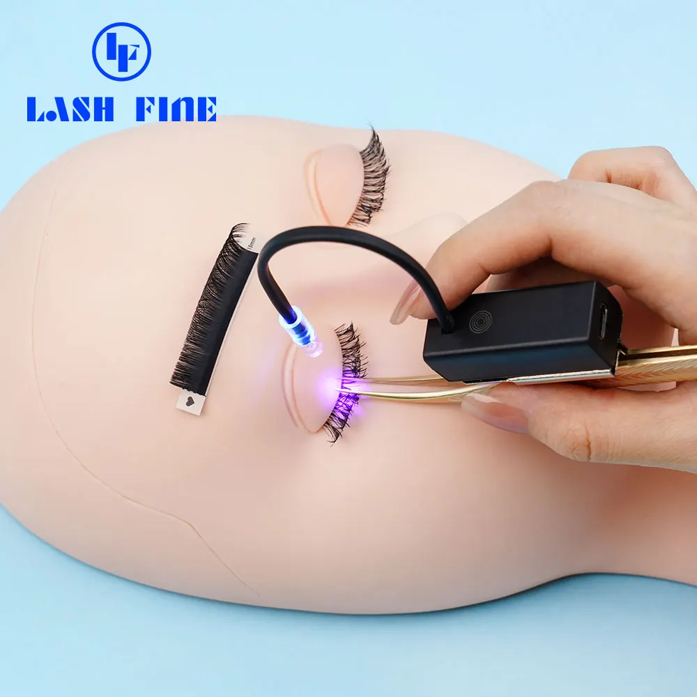 Lash Fine UV LED tweezer lamp curing a lash extension bond on a training head